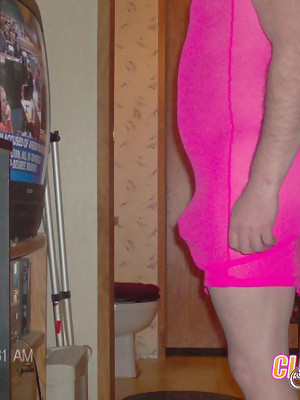 Crossdresser wearing a pink dress and riding a dildo